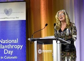 Sue Zoby accepting National Philanthropy Day Outstanding Service Organization Award Sue Zoby speaking in front of a podium